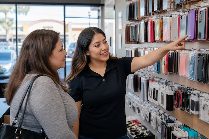 Wireless Inc team member helping a customer choose a phone case at the Victory Drive store in Columbus, GA